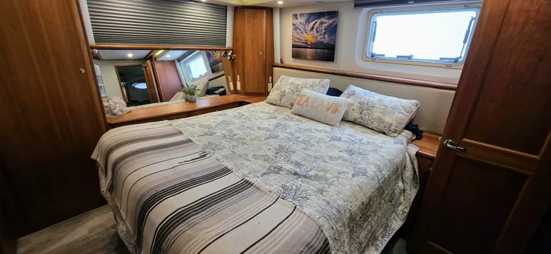  Yacht Photos Pics Luxurious bedroom in 2000 Silverton 453MY yacht with cozy bedding and elegant wood finishes.