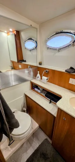  Yacht Photos Pics Bathroom interior of a 2000 Silverton 453MY yacht with porthole windows.