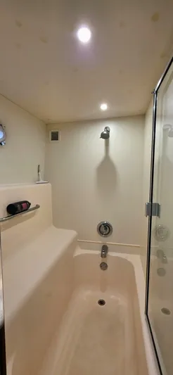  Yacht Photos Pics Bathroom interior of a 2000 Silverton 453MY yacht with a shower and tub.