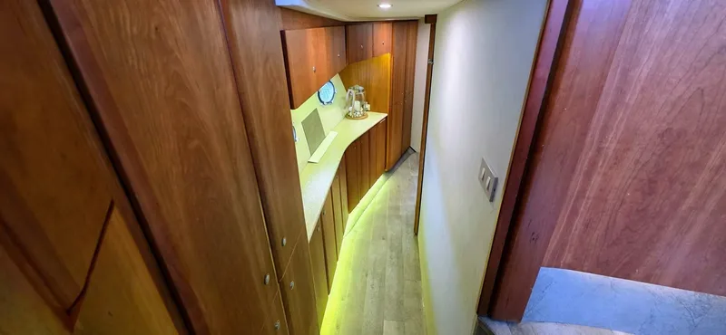  Yacht Photos Pics Interior hallway of 2000 Silverton 453MY yacht with wooden cabinetry and modern lighting.