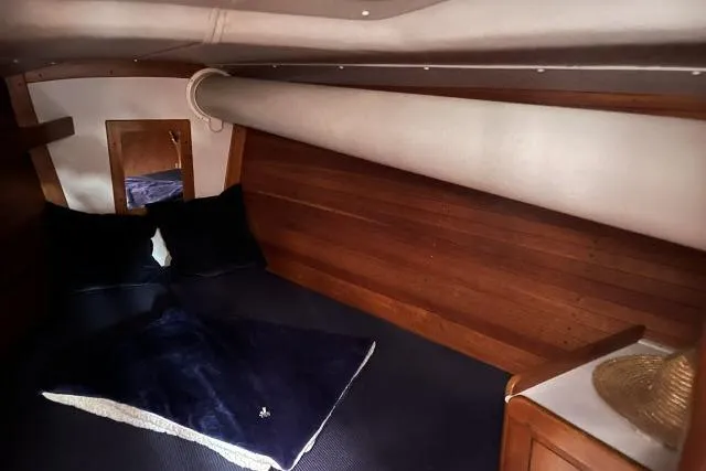 G Force Yacht Photos Pics Cozy cabin interior of 2004 J Boats J/133 with wooden paneling and bedding.