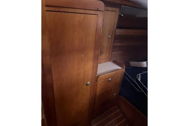 G Force Yacht Photos Pics Interior of 2004 J Boats J/133, featuring wooden cabinetry and sleek design elements.