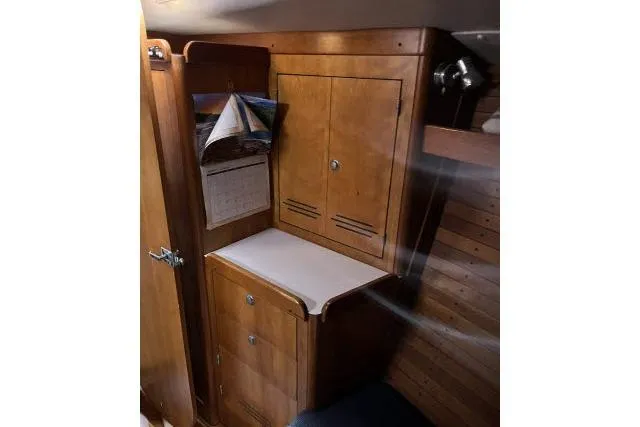 G Force Yacht Photos Pics 2004 J Boats J/133 interior with wooden cabinetry and foldable table.