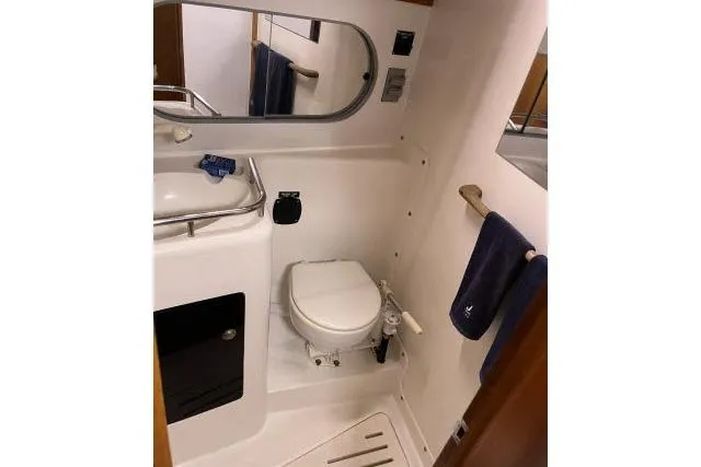 G Force Yacht Photos Pics 2004 J Boats J/133 yacht bathroom with toilet, sink, mirror, and towel rack.