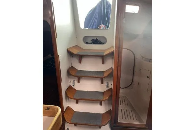 G Force Yacht Photos Pics Interior stairs of 2004 J Boats J/133 sailboat with wooden steps.