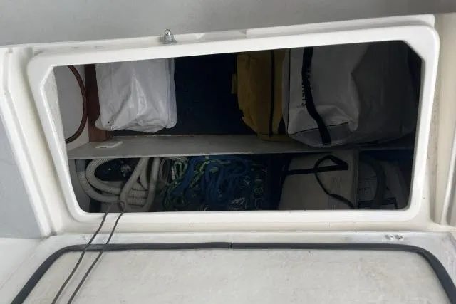 G Force Yacht Photos Pics Storage compartment on a 2004 J Boats J/133, containing ropes and bags.