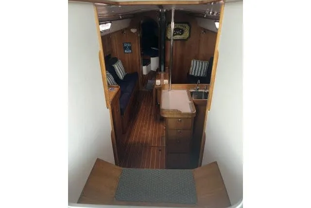 G Force Yacht Photos Pics Interior of 2004 J Boats J/133 sailboat, featuring wood finish and compact galley.