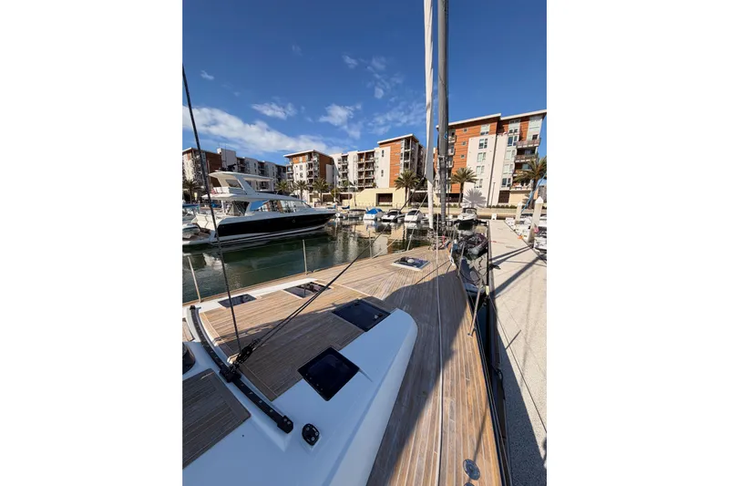 Gazelle II Yacht Photos Pics Beneteau Oceanis Yacht 60, 2015, docked in marina with modern buildings in background.