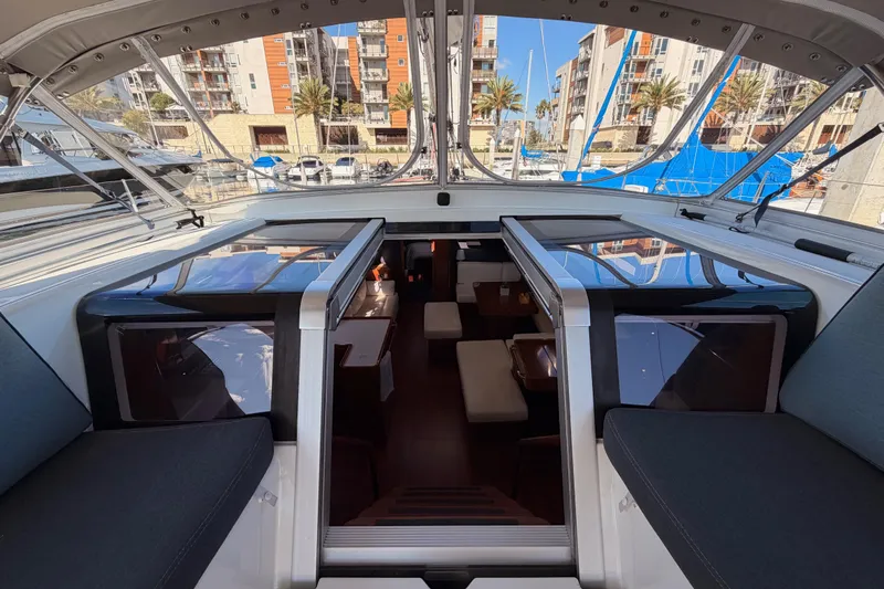 Gazelle II Yacht Photos Pics Interior view of 2015 Beneteau Oceanis Yacht 60, showcasing luxurious cabin and marina backdrop.
