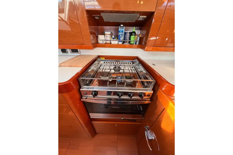 Gazelle II Yacht Photos Pics Galley kitchen in 2015 Beneteau Oceanis Yacht 60 with stove and wooden cabinetry.