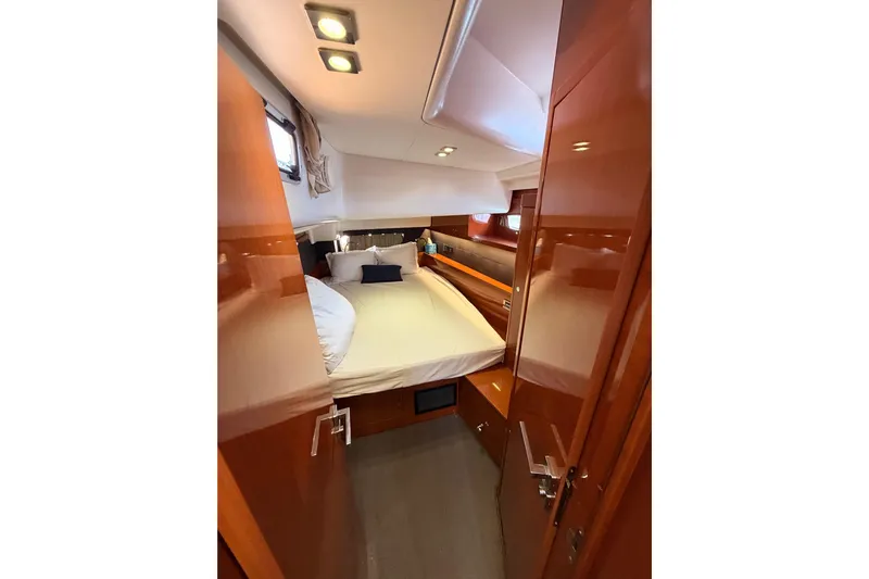 Gazelle II Yacht Photos Pics Luxurious cabin interior of 2015 Beneteau Oceanis Yacht 60 with cozy bed and wooden finish.