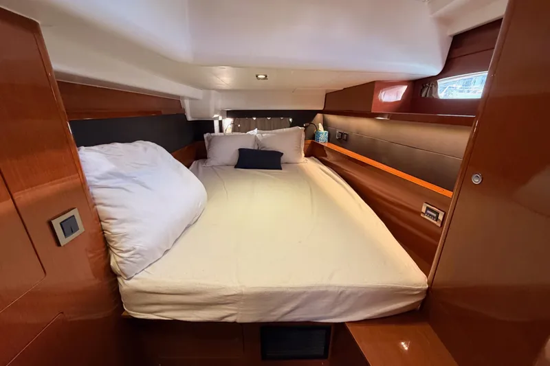 Gazelle II Yacht Photos Pics Luxurious cabin interior of 2015 Beneteau Oceanis Yacht 60 with cozy bed and wooden finish.