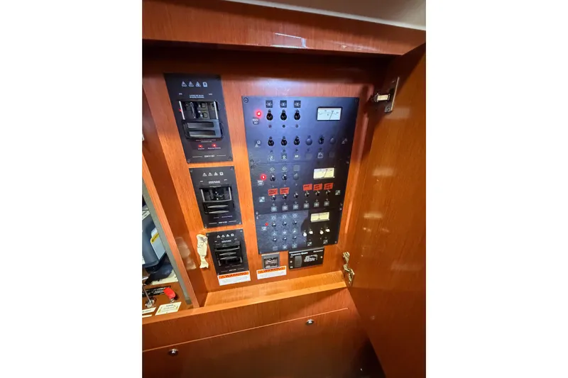 Gazelle II Yacht Photos Pics Electrical control panel inside 2015 Beneteau Oceanis Yacht 60, featuring switches and indicators.