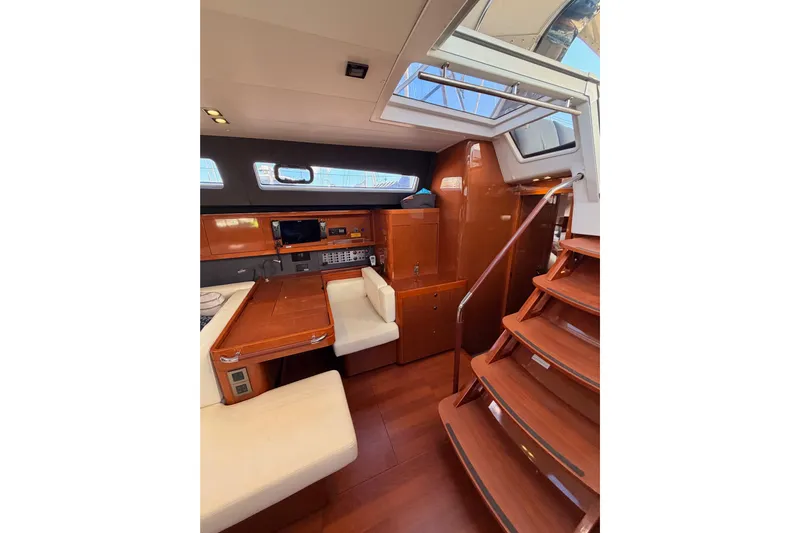 Gazelle II Yacht Photos Pics Luxurious interior of 2015 Beneteau Oceanis Yacht 60 with wooden finishes and seating area.