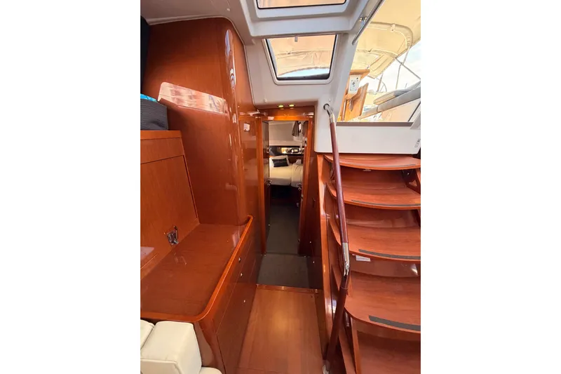 Gazelle II Yacht Photos Pics Interior view of 2015 Beneteau Oceanis Yacht 60, featuring elegant wooden finishes and staircase.