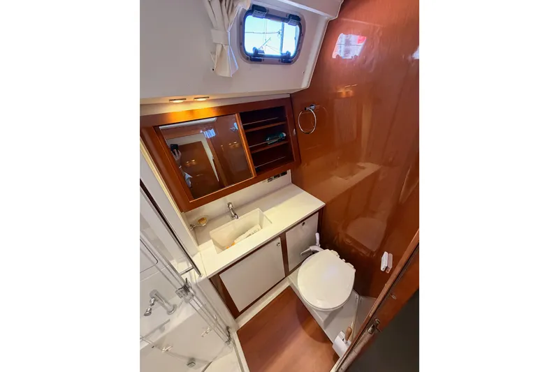 Gazelle II Yacht Photos Pics Luxurious bathroom in 2015 Beneteau Oceanis Yacht 60, featuring modern fixtures and wood accents.