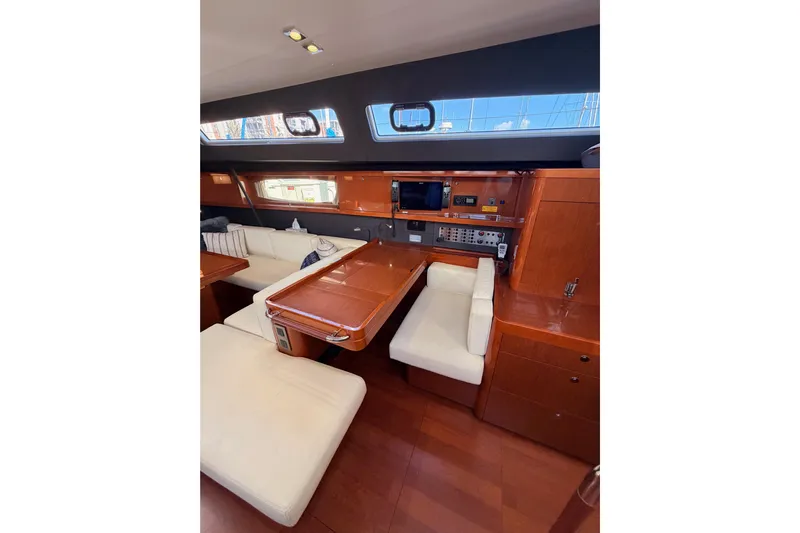 Gazelle II Yacht Photos Pics Luxurious interior of 2015 Beneteau Oceanis Yacht 60 with elegant seating and navigation area.