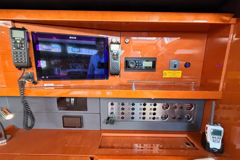 Gazelle II Yacht Photos Pics Control panel of a 2015 Beneteau Oceanis Yacht 60 with navigation and communication equipment.