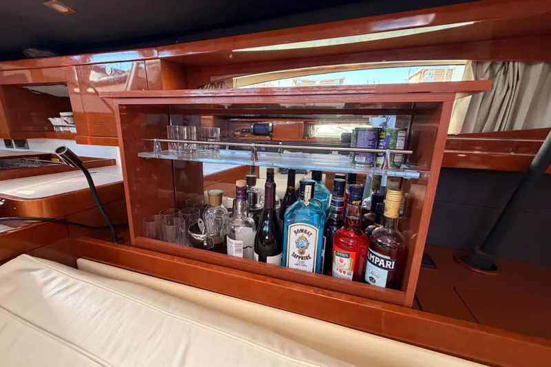 Gazelle II Yacht Photos Pics Luxurious bar area on 2015 Beneteau Oceanis Yacht 60 with assorted spirits and glassware.