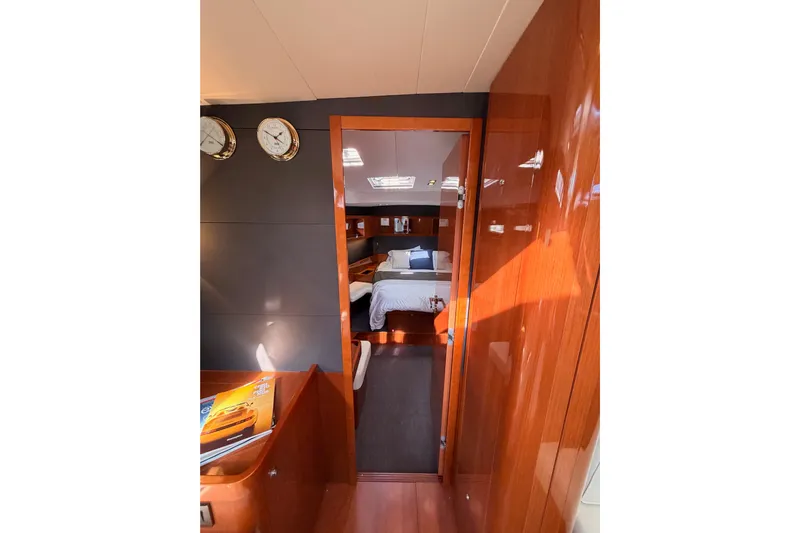 Gazelle II Yacht Photos Pics Luxurious interior of 2015 Beneteau Oceanis Yacht 60, featuring elegant wood finishes and cozy cabin.