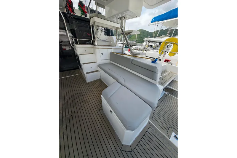 Old Marblehead Yacht Photos Pics 2019 Leopard 50 yacht interior with cushioned seating and wooden flooring.
