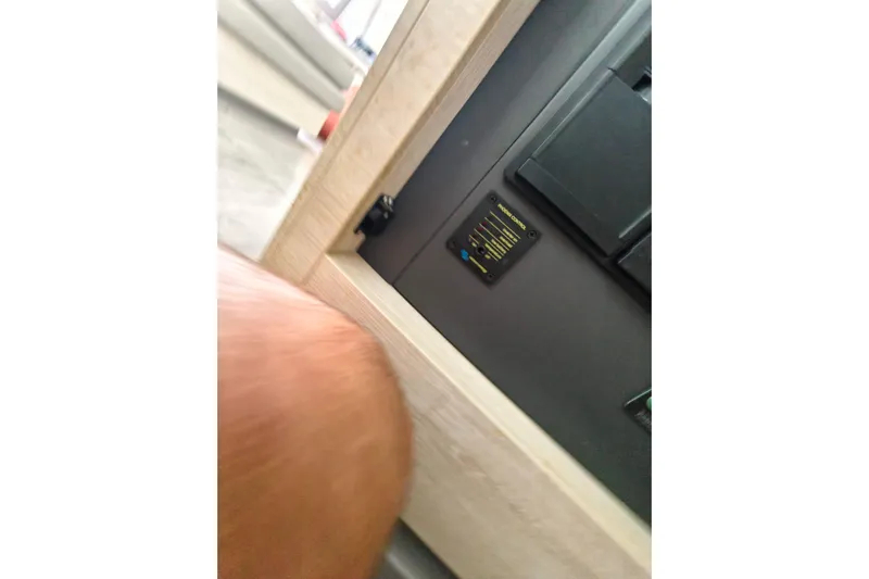 Old Marblehead Yacht Photos Pics Control panel inside a 2019 Leopard 50 yacht, featuring a wooden frame.