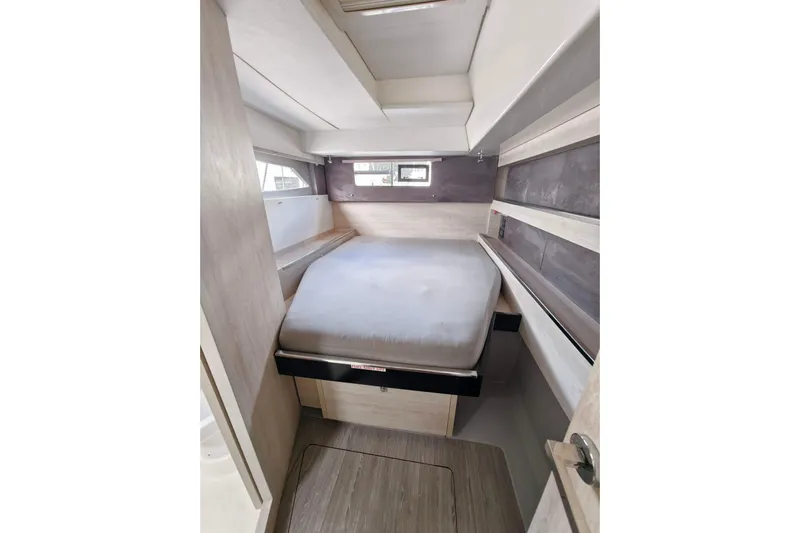 Old Marblehead Yacht Photos Pics Compact cabin interior of 2019 Leopard 50 yacht with bed and window.