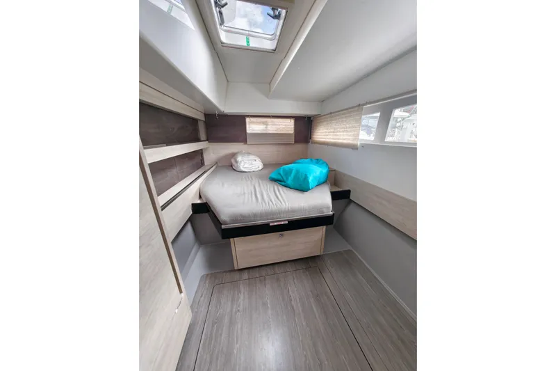 Old Marblehead Yacht Photos Pics Cozy cabin interior of 2019 Leopard 50 yacht with bed and skylight.