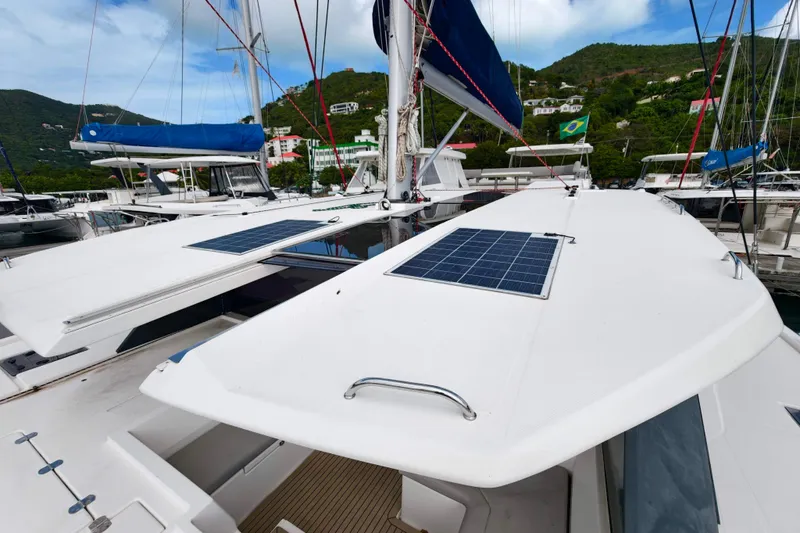 Old Marblehead Yacht Photos Pics 2019 Leopard 50 catamaran with solar panels docked in a scenic marina.