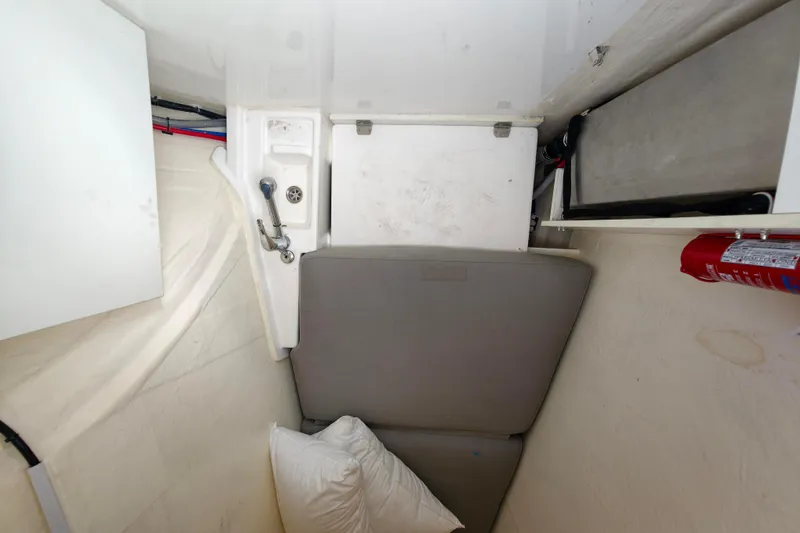 Old Marblehead Yacht Photos Pics Compact interior of 2019 Leopard 50 yacht with seating, sink, and fire extinguisher.