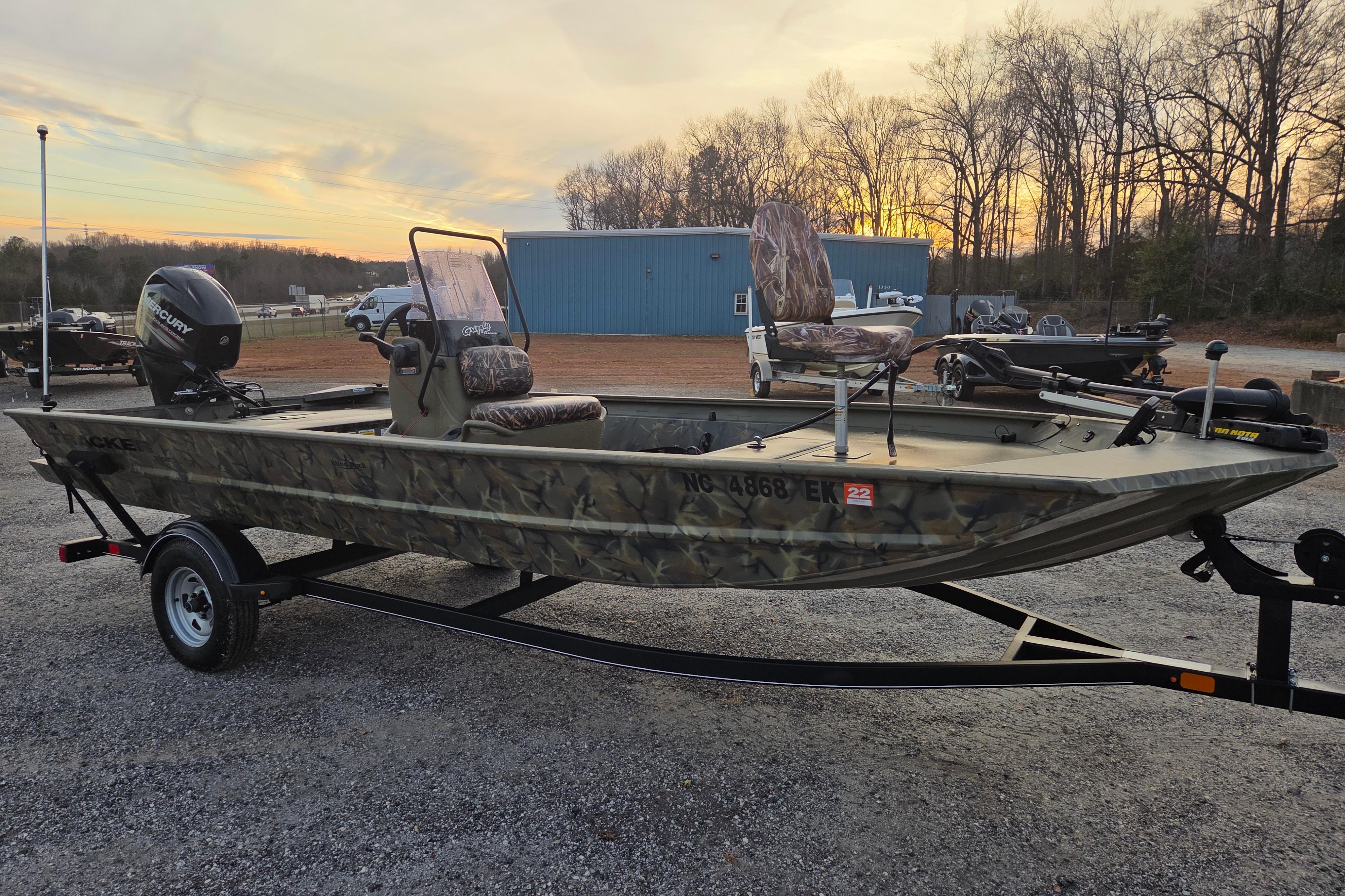 2018 Tracker Grizzly 1860 CC boat on trailer at sunset, camo design, outdoor setting.