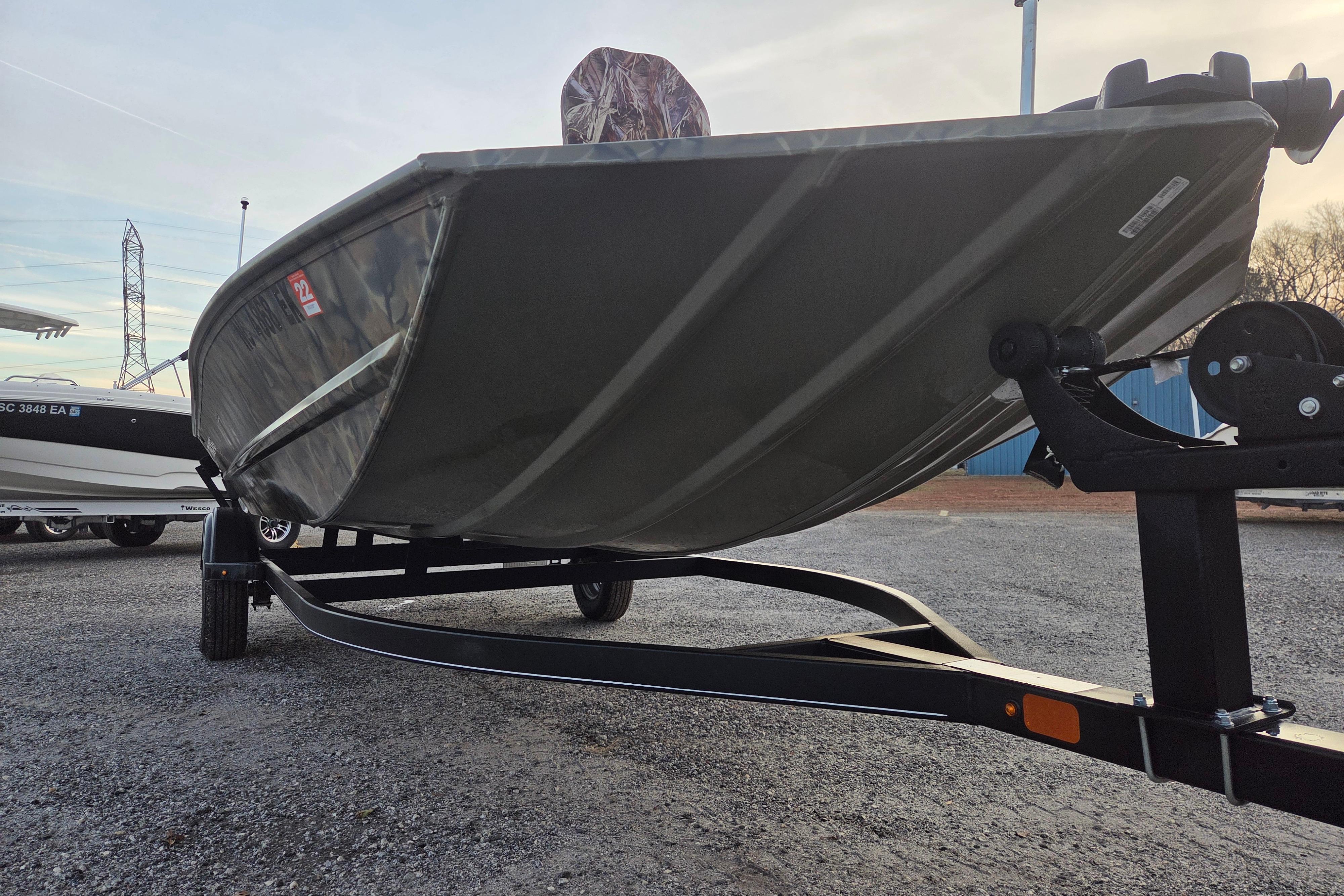 2018 Tracker Grizzly 1860 CC boat on trailer, parked outdoors.