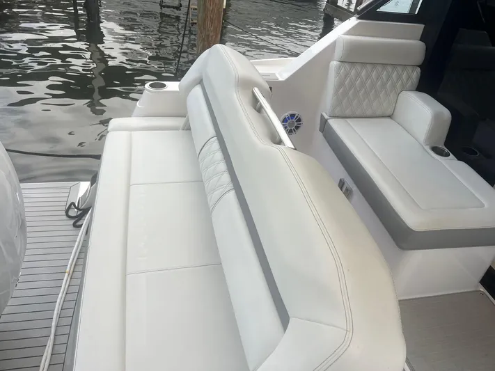  Yacht Photos Pics 2023 Regal 36 XO boat interior with white leather seating and cup holders.