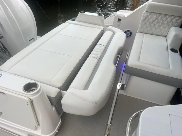 Yacht Photos Pics 2023 Regal 36 XO boat interior with luxurious white seating and cup holders.