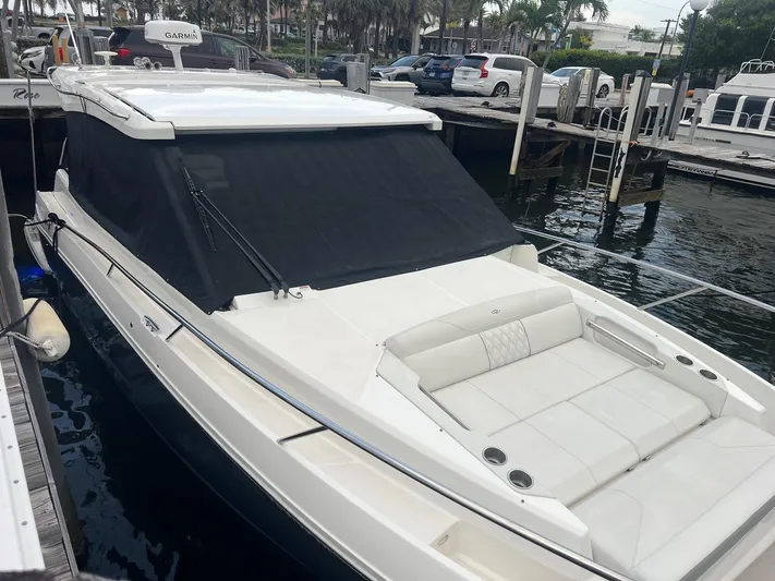  Yacht Photos Pics 2023 Regal 36 XO boat docked, featuring sleek design and spacious seating area.