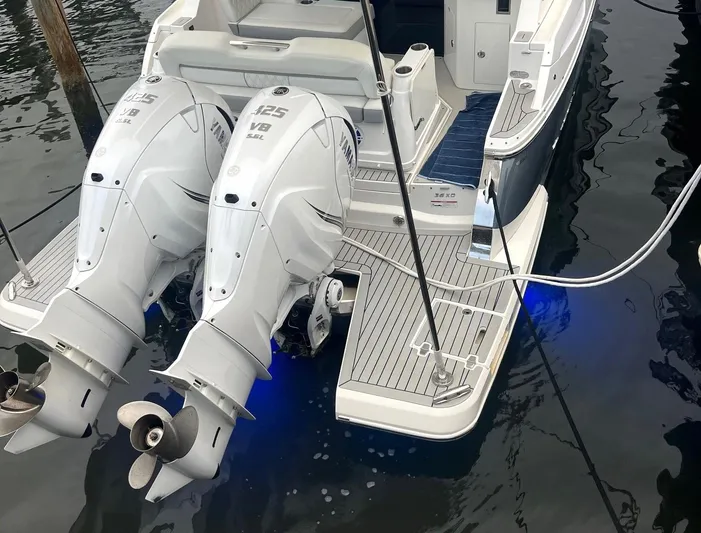  Yacht Photos Pics 2023 Regal 36 XO boat with twin Yamaha V8 outboard engines docked on water.