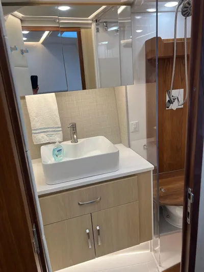  Yacht Photos Pics Modern bathroom in 2023 Regal 36 XO yacht with sink, mirror, and shower.