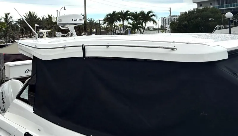  Yacht Photos Pics 2023 Regal 36 XO boat with Garmin radar, docked near palm trees.