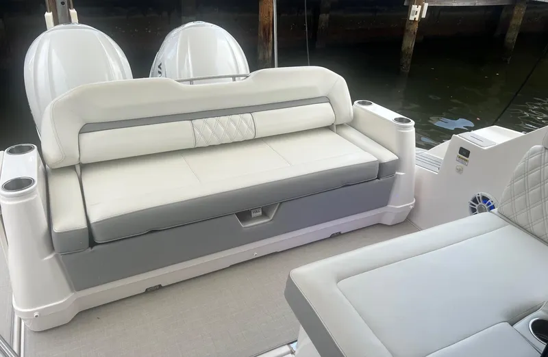 Yacht Photos Pics 2023 Regal 36 XO boat interior with cushioned seating and dual outboard motors.