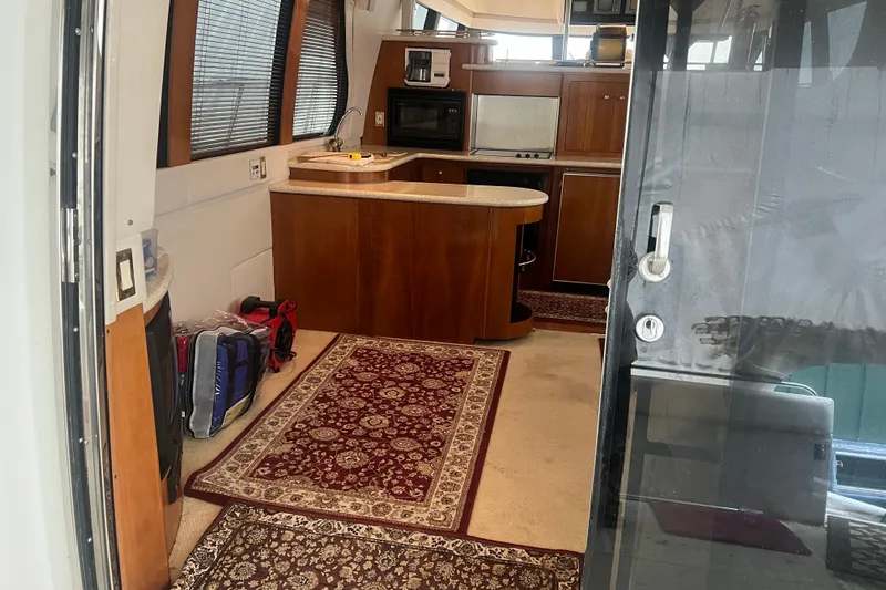 Betty Jean Yacht Photos Pics Interior of 2000 Carver 530 Voyager Pilothouse with kitchen and rugs.