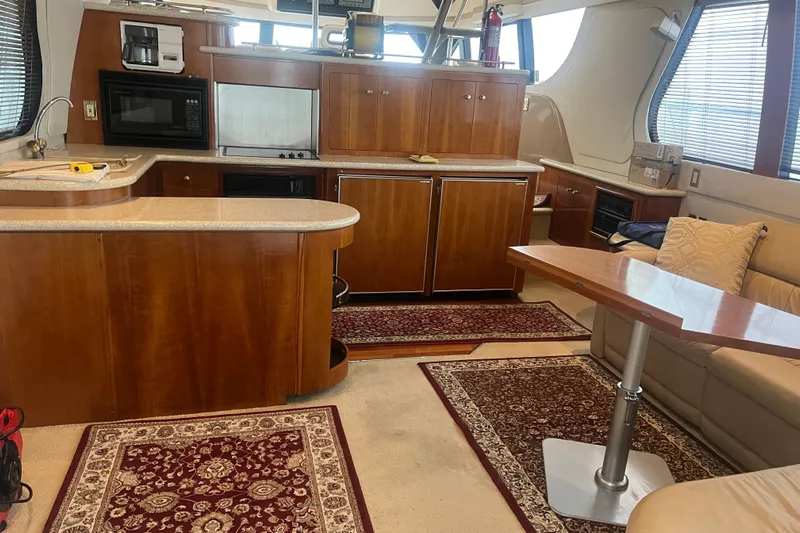 Betty Jean Yacht Photos Pics Luxurious interior of 2000 Carver 530 Voyager Pilothouse with kitchen and seating area.