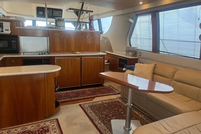 Betty Jean Yacht Photos Pics Luxurious interior of 2000 Carver 530 Voyager Pilothouse with kitchen and seating area.
