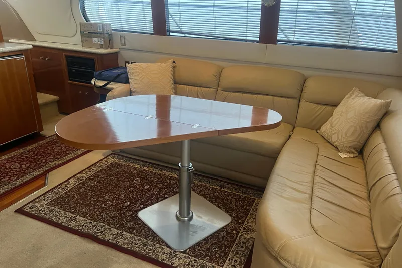 Betty Jean Yacht Photos Pics Luxurious interior of 2000 Carver 530 Voyager Pilothouse with leather seating and elegant table.