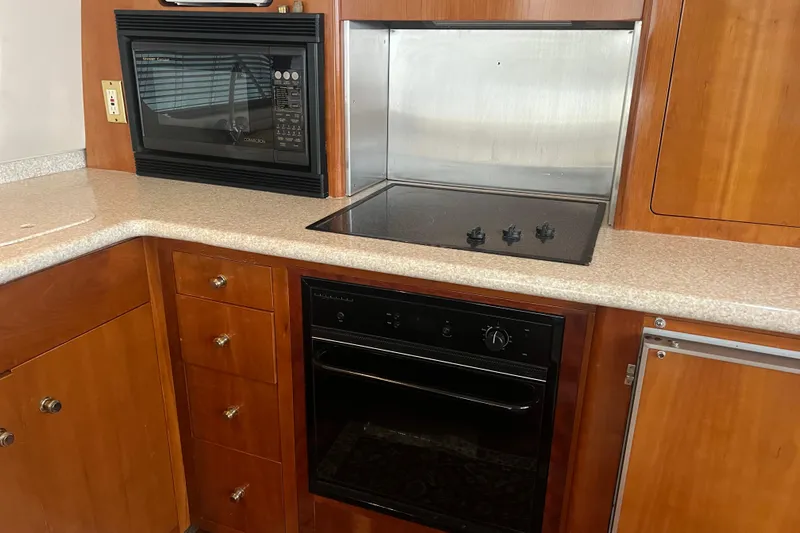 Betty Jean Yacht Photos Pics Kitchen area of 2000 Carver 530 Voyager Pilothouse with microwave and stove.