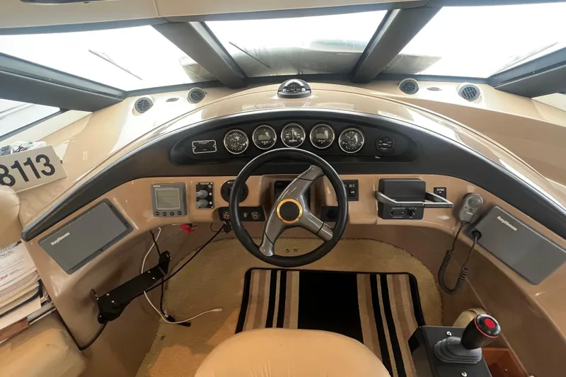 Betty Jean Yacht Photos Pics Pilothouse interior of 2000 Carver 530 Voyager, featuring steering wheel and navigation instruments.