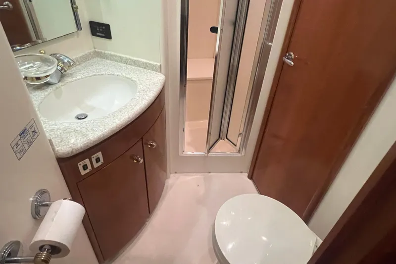 Betty Jean Yacht Photos Pics Bathroom interior of 2000 Carver 530 Voyager Pilothouse with sink, toilet, and shower.