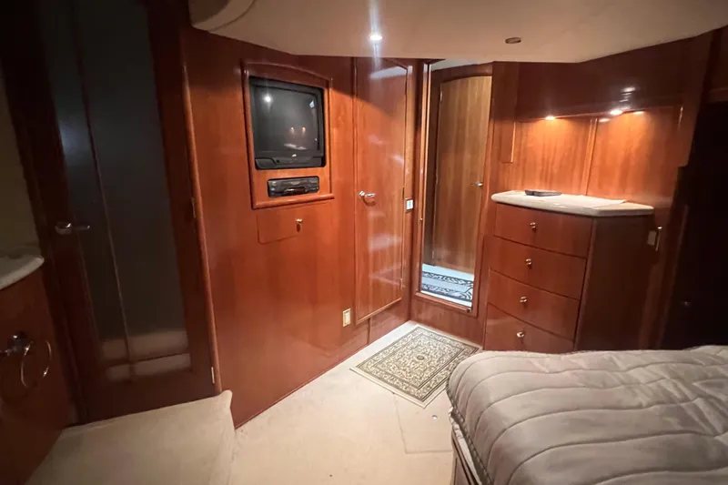 Betty Jean Yacht Photos Pics Luxurious interior of 2000 Carver 530 Voyager Pilothouse with wood paneling and built-in TV.
