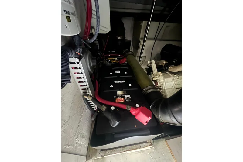 Betty Jean Yacht Photos Pics Engine room of 2000 Carver 530 Voyager Pilothouse with visible batteries and wiring.