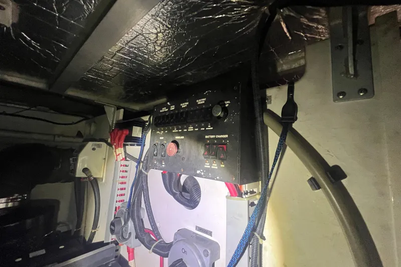 Betty Jean Yacht Photos Pics Electrical panel inside 2000 Carver 530 Voyager Pilothouse, featuring battery charger and wiring.