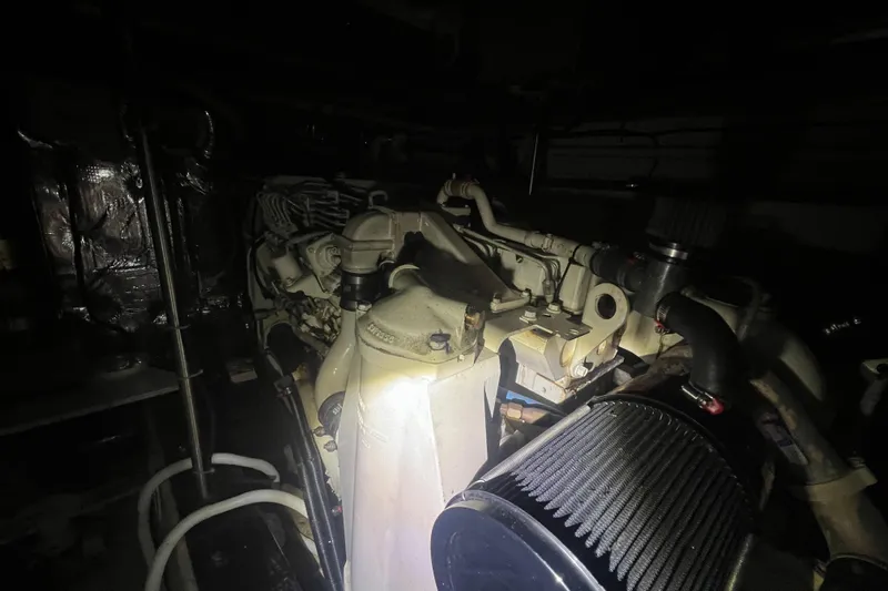 Betty Jean Yacht Photos Pics Engine room of a 2000 Carver 530 Voyager Pilothouse, dimly lit with visible components.